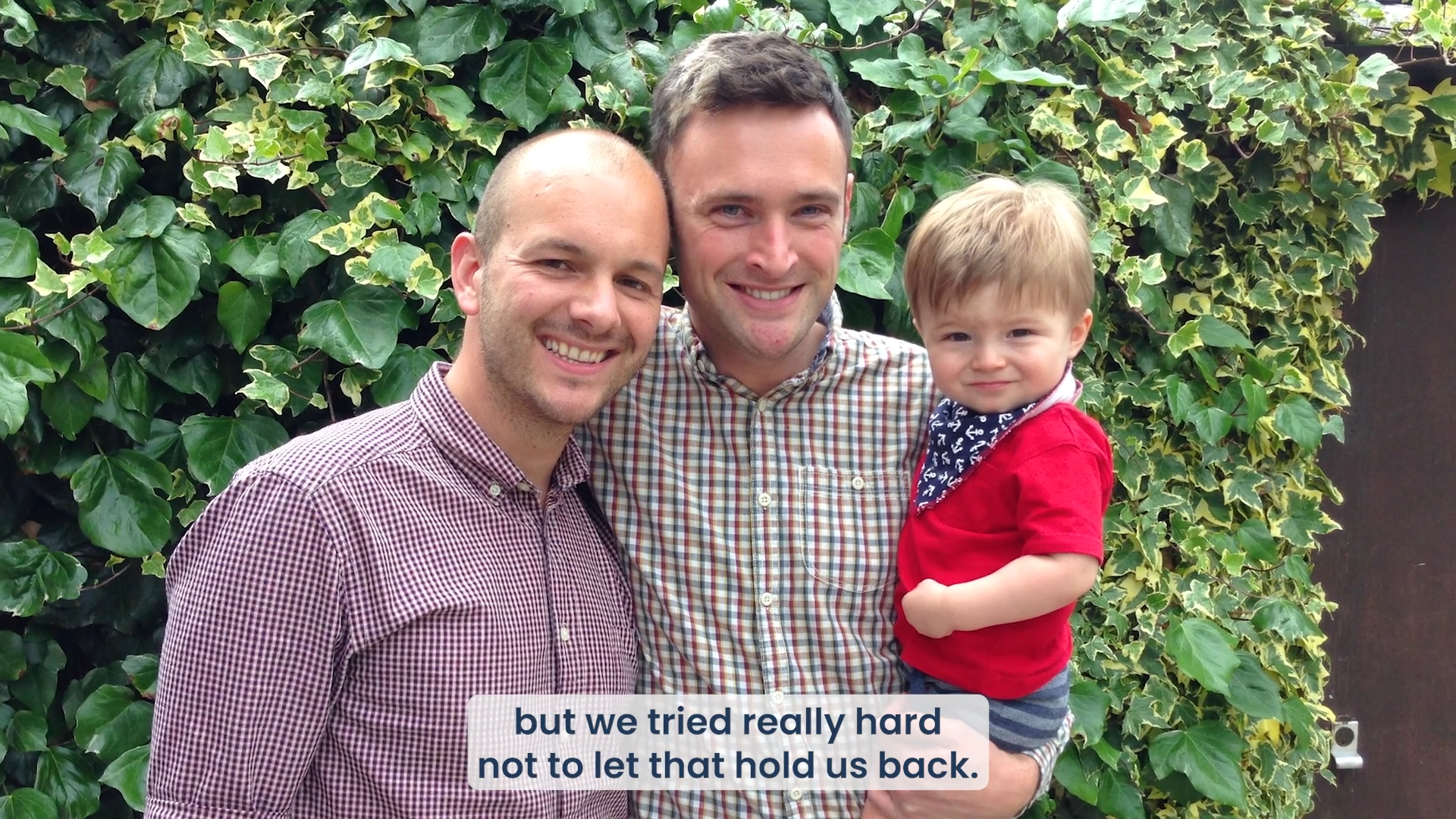 Two Dads & Child In Garden