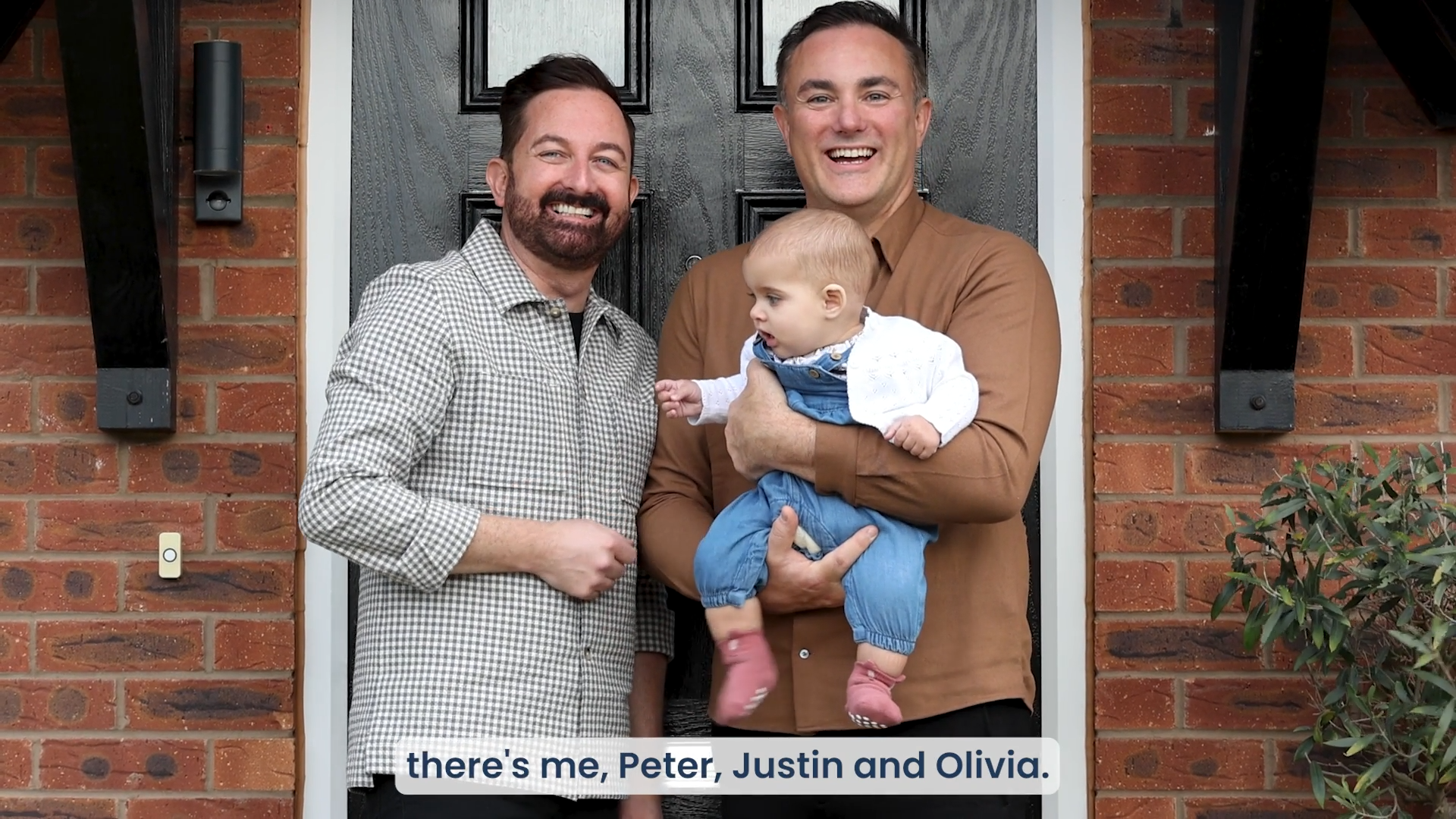 Two Dads & Child Outside House